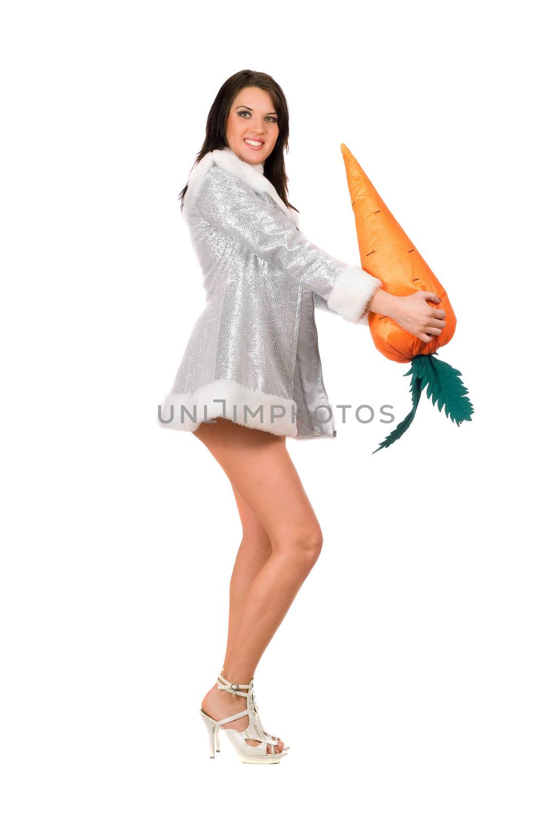 Beautiful young brunette with a carrot. Isolated