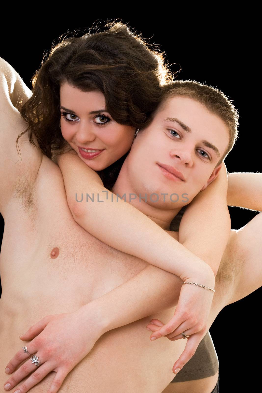 Beautiful playful young couple. Isolated on black background