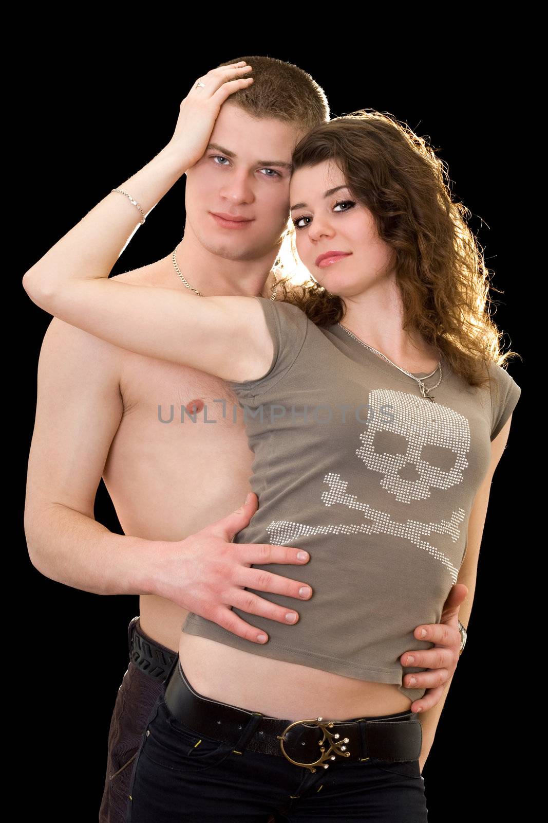 Pretty loving young couple. Isolated on black