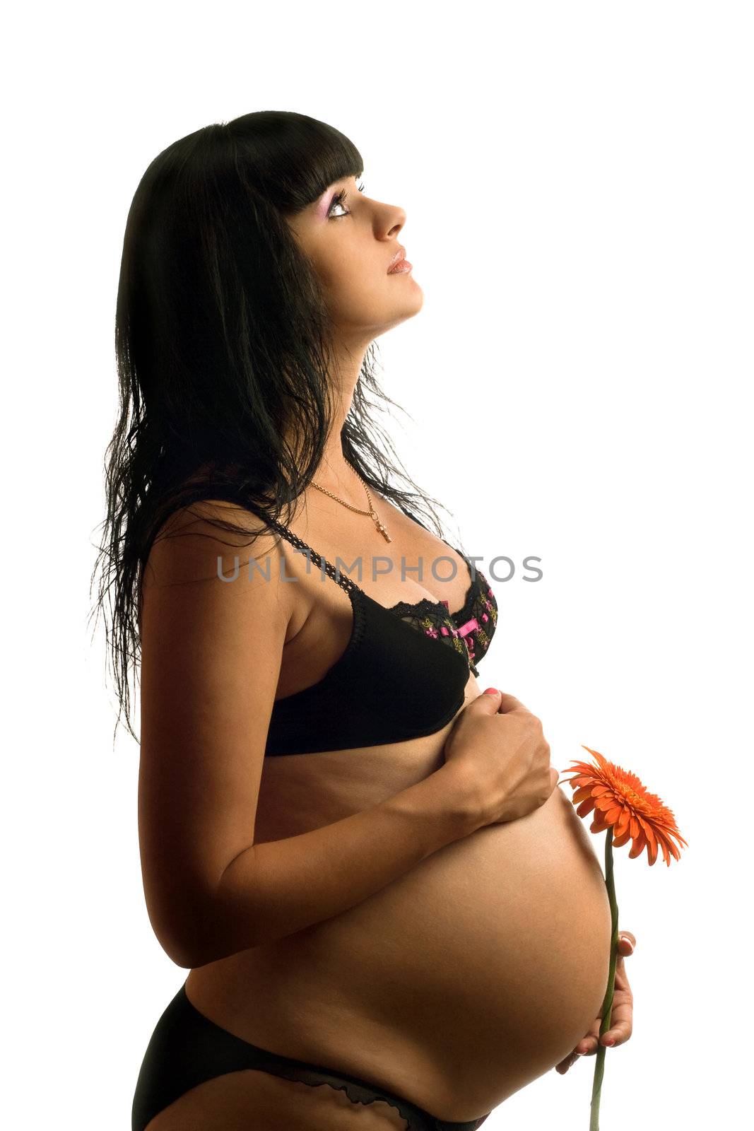 Pregnant young woman with flower. Isolated on white