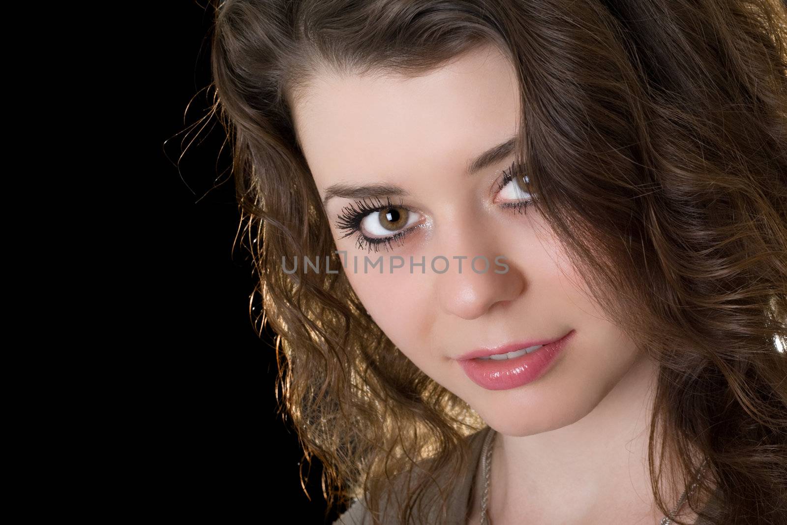 Portrait of the beautiful girl. Isolated on black