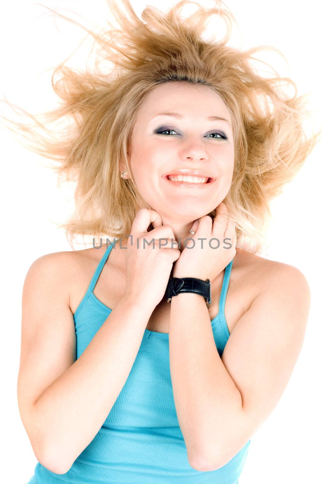 Portrait of cheerful young blond girl lying on a white