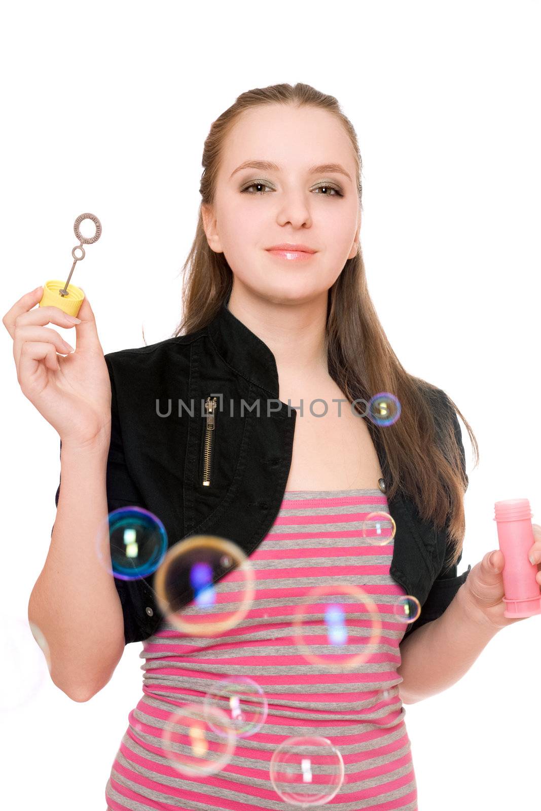 Portrait of smiling young woman blow bubbles. Isolated