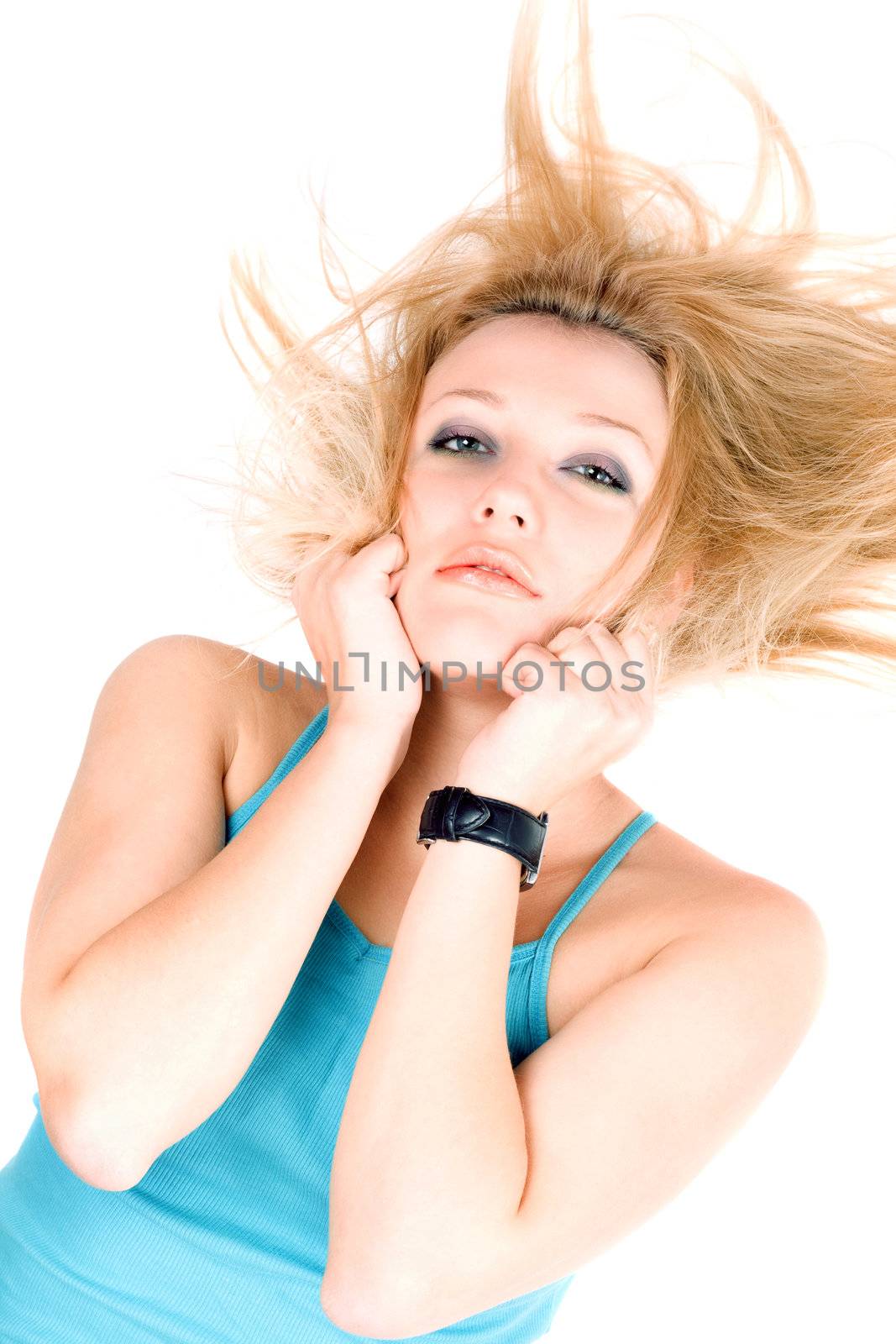 Portrait of pretty young blond girl lying on a white