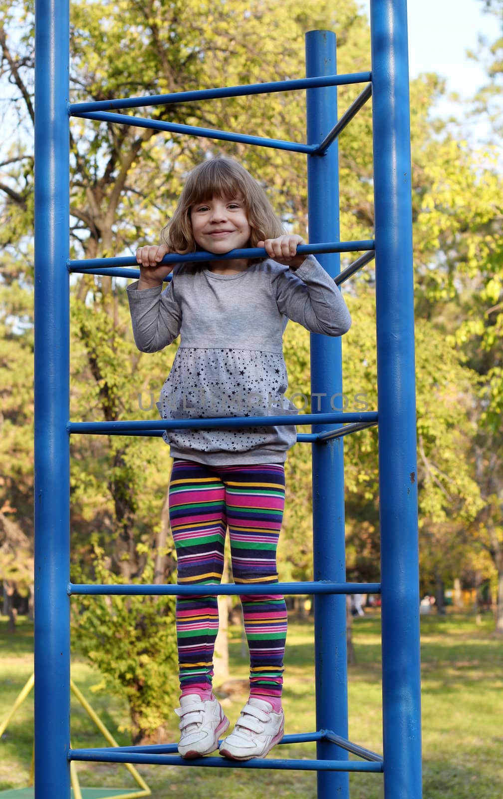 little girl fun on playground by goce