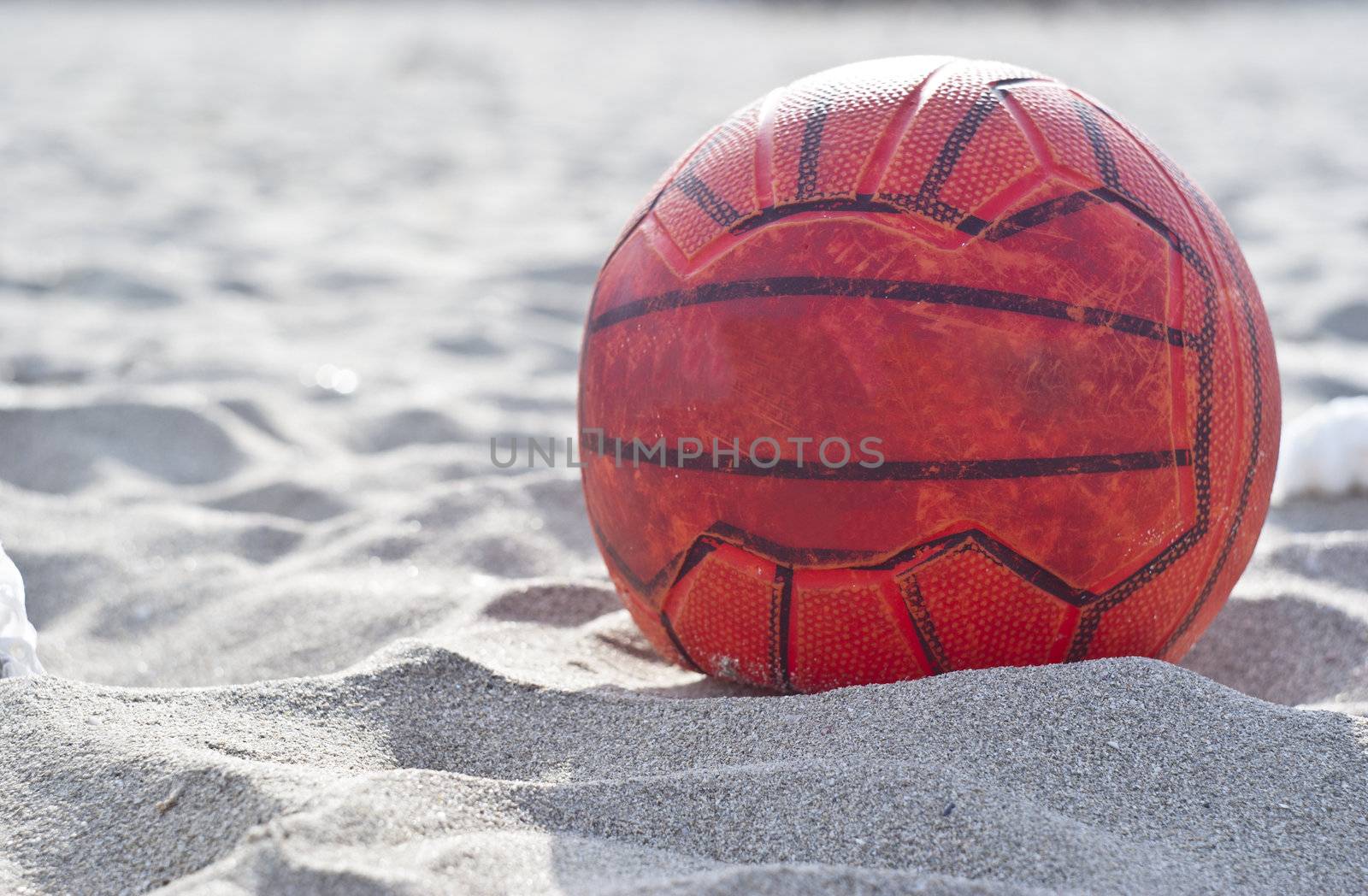 orange soccer ball on beach. horizontal