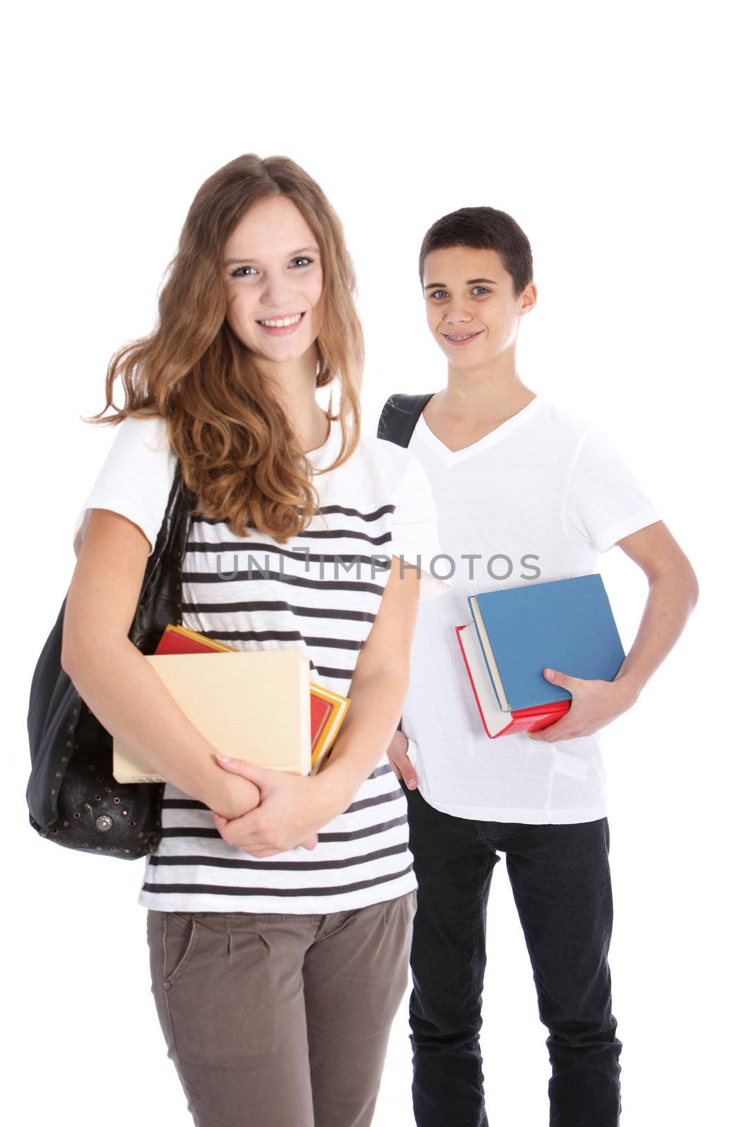 Two smiling teenagers with school supplies isolated on white in studio