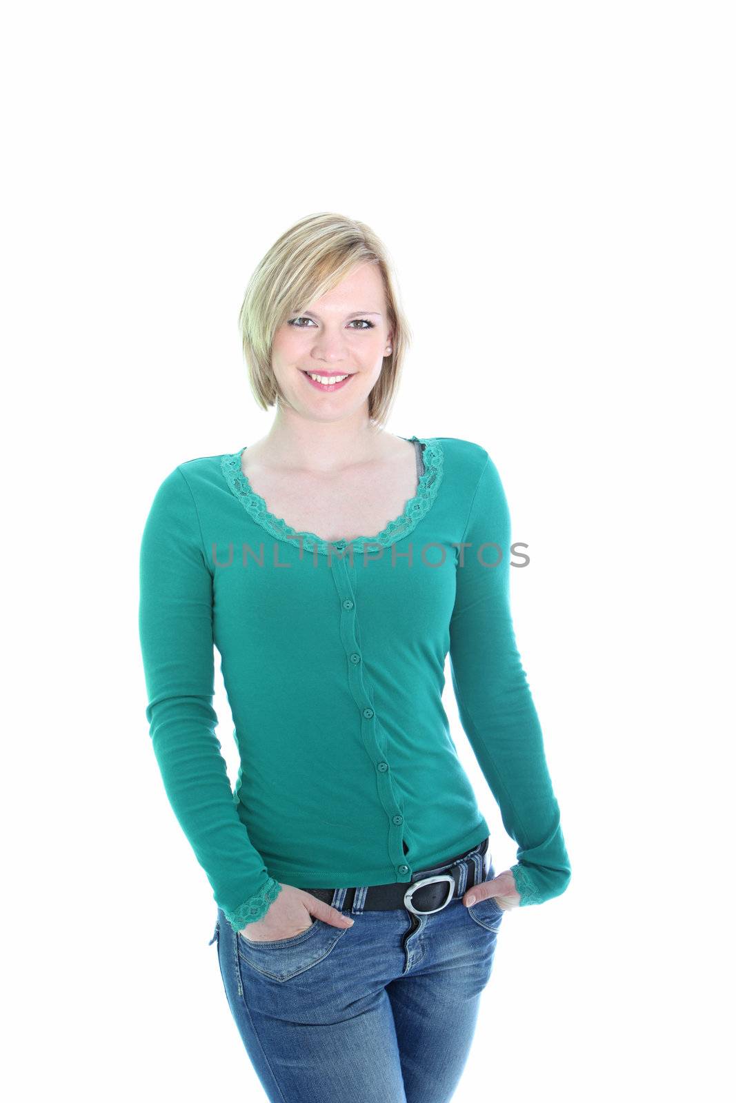 Three quarter studio portrait of a sexy curvy young blonde woman in jeans posing with her hands in her pockets isolated on white