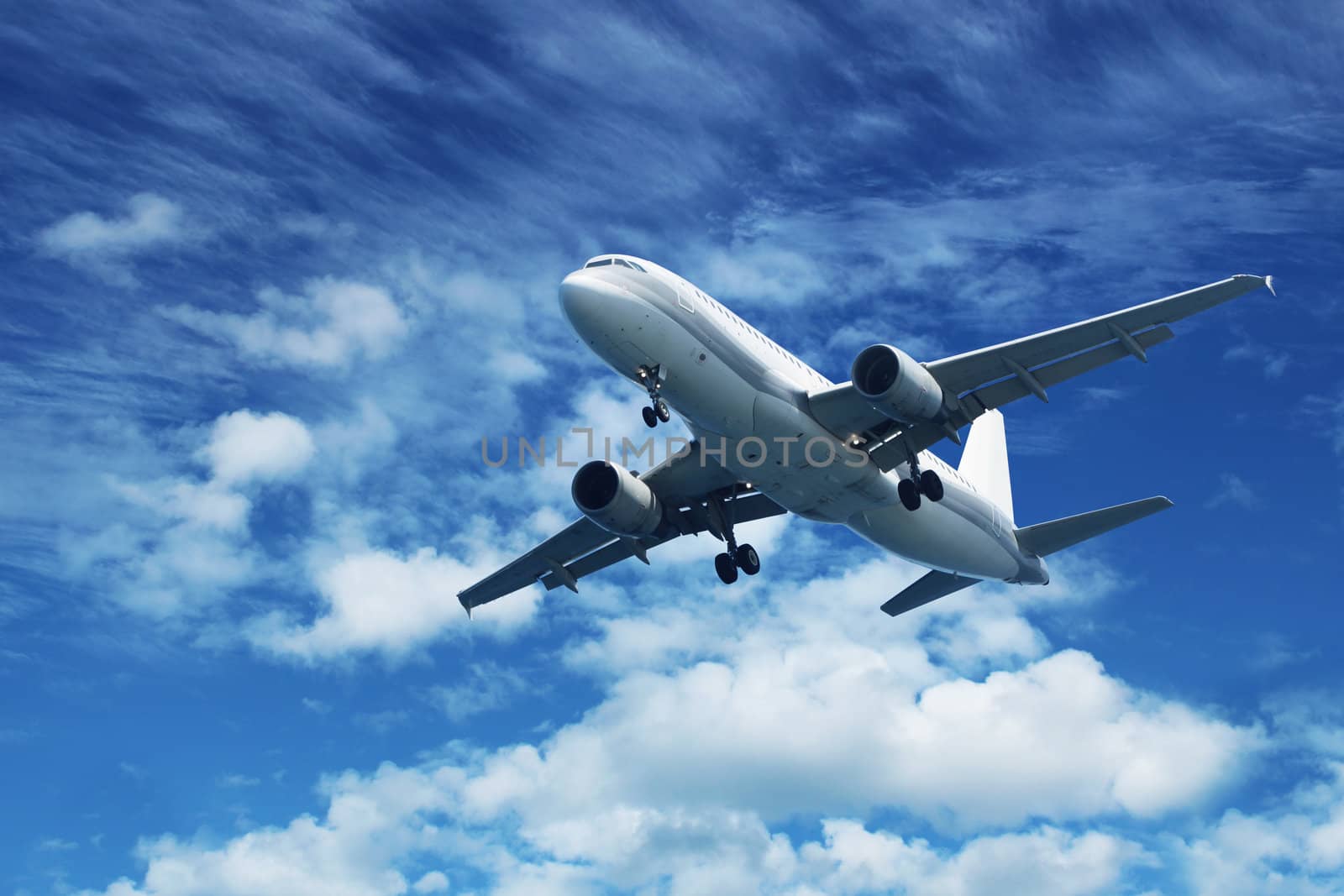 Passenger air plane flying on blue sky white clouds background