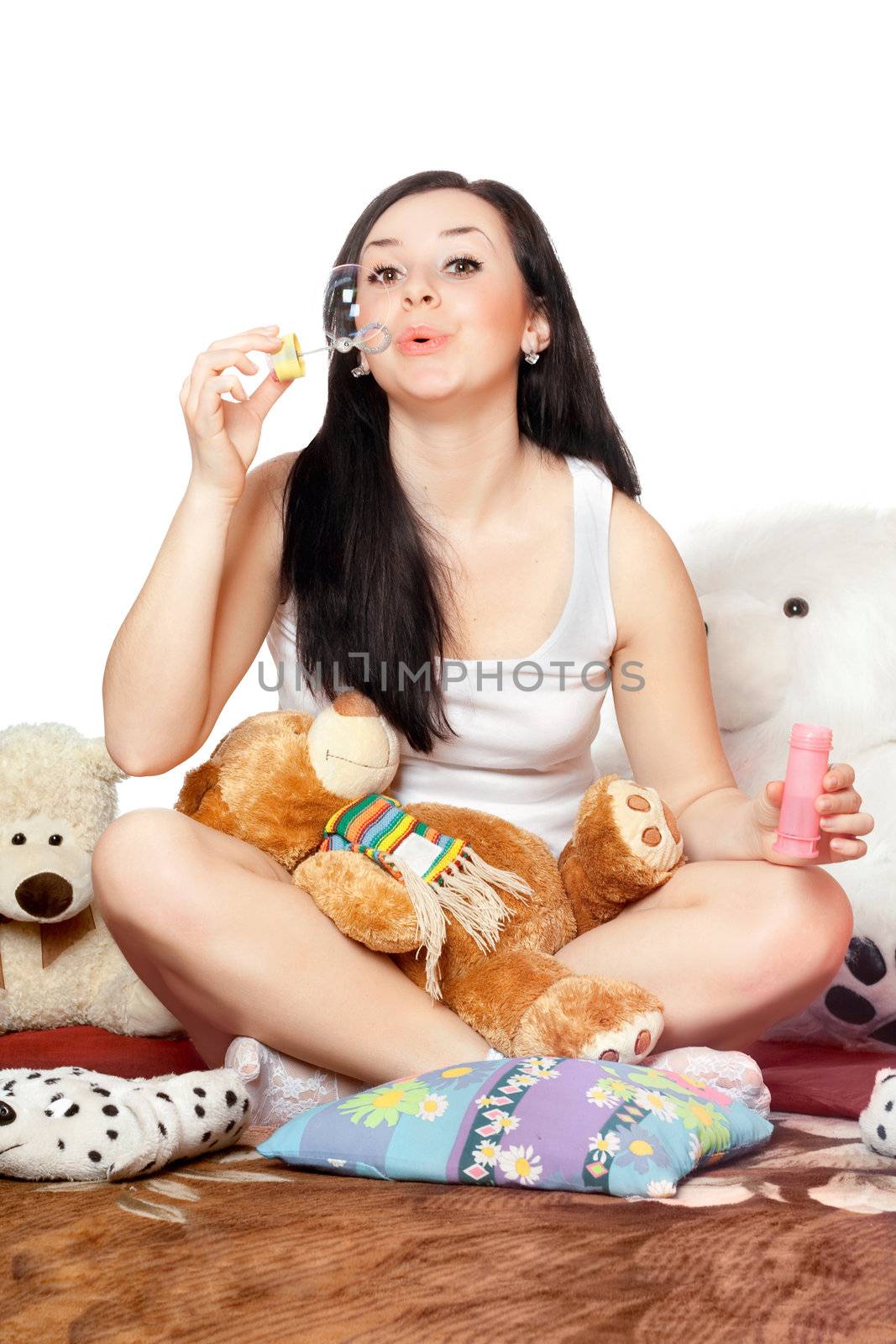 Playful pretty girl blow bubbles. Isolated on white