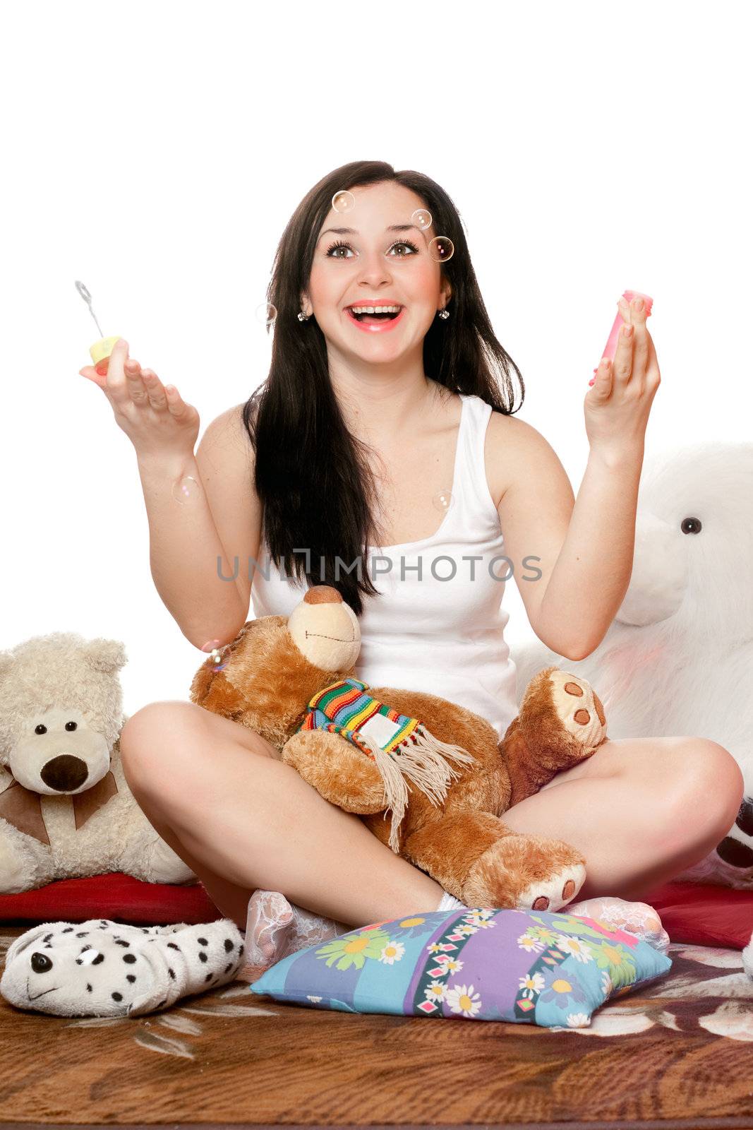 Happy girl blow bubbles. Isolated on white
