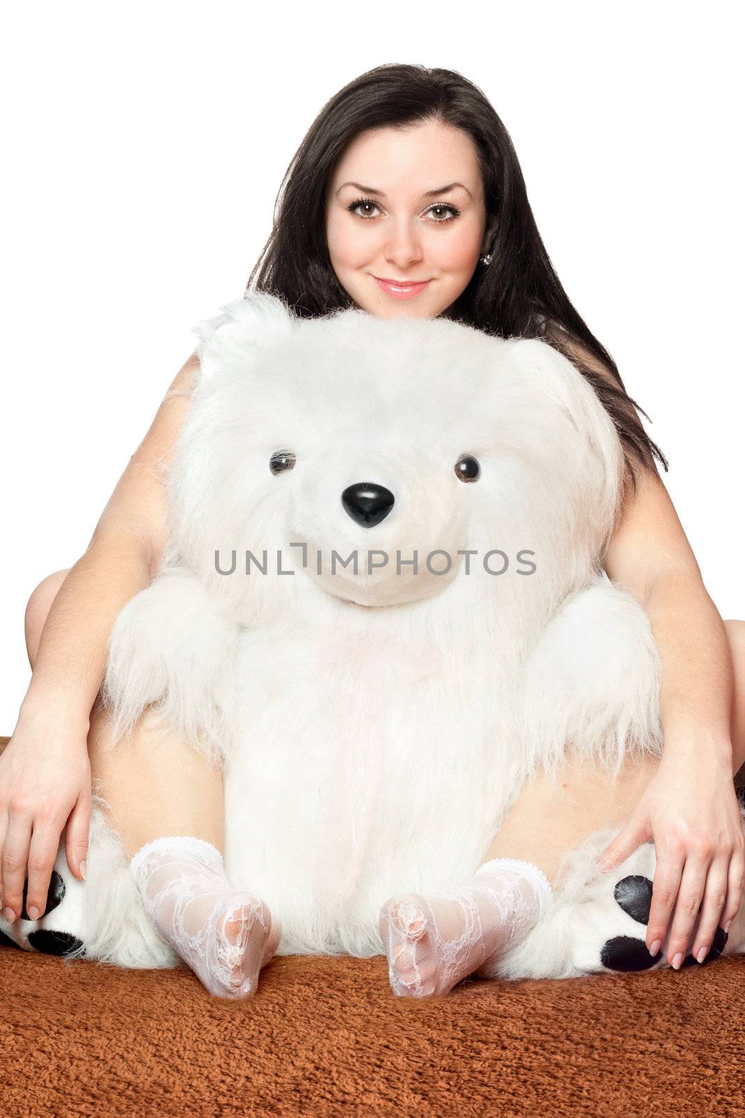 Smiling girl sitting with a large teddy bear