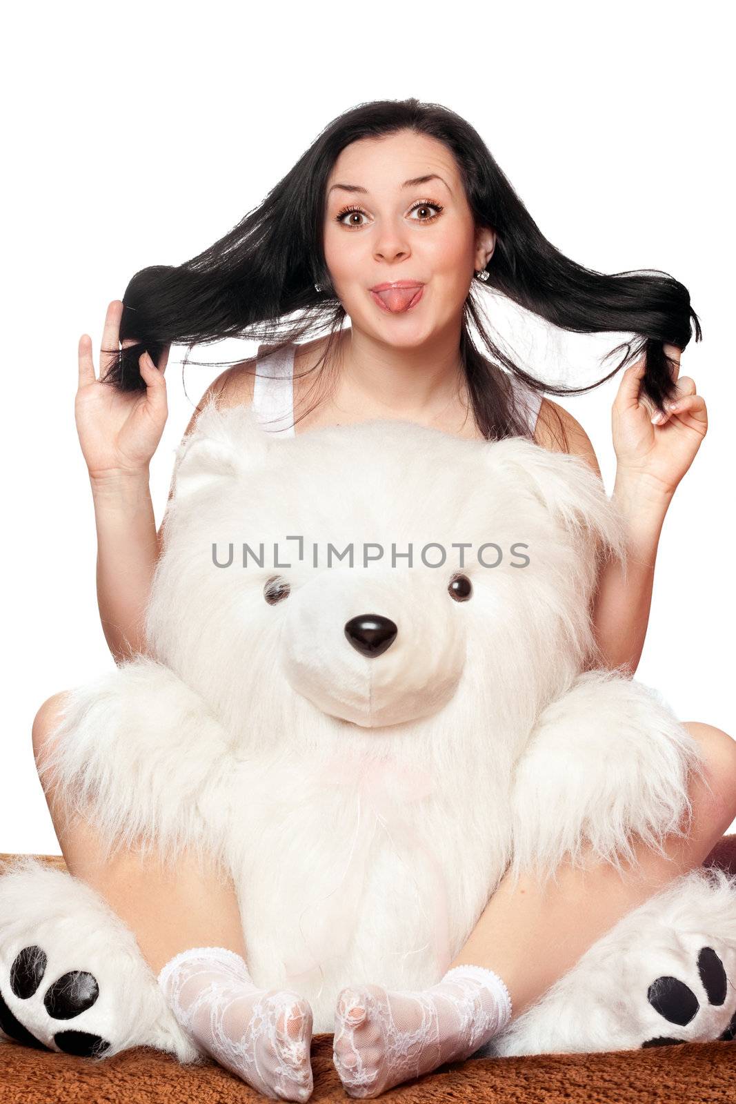 Cheerful girl with a big teddy bear