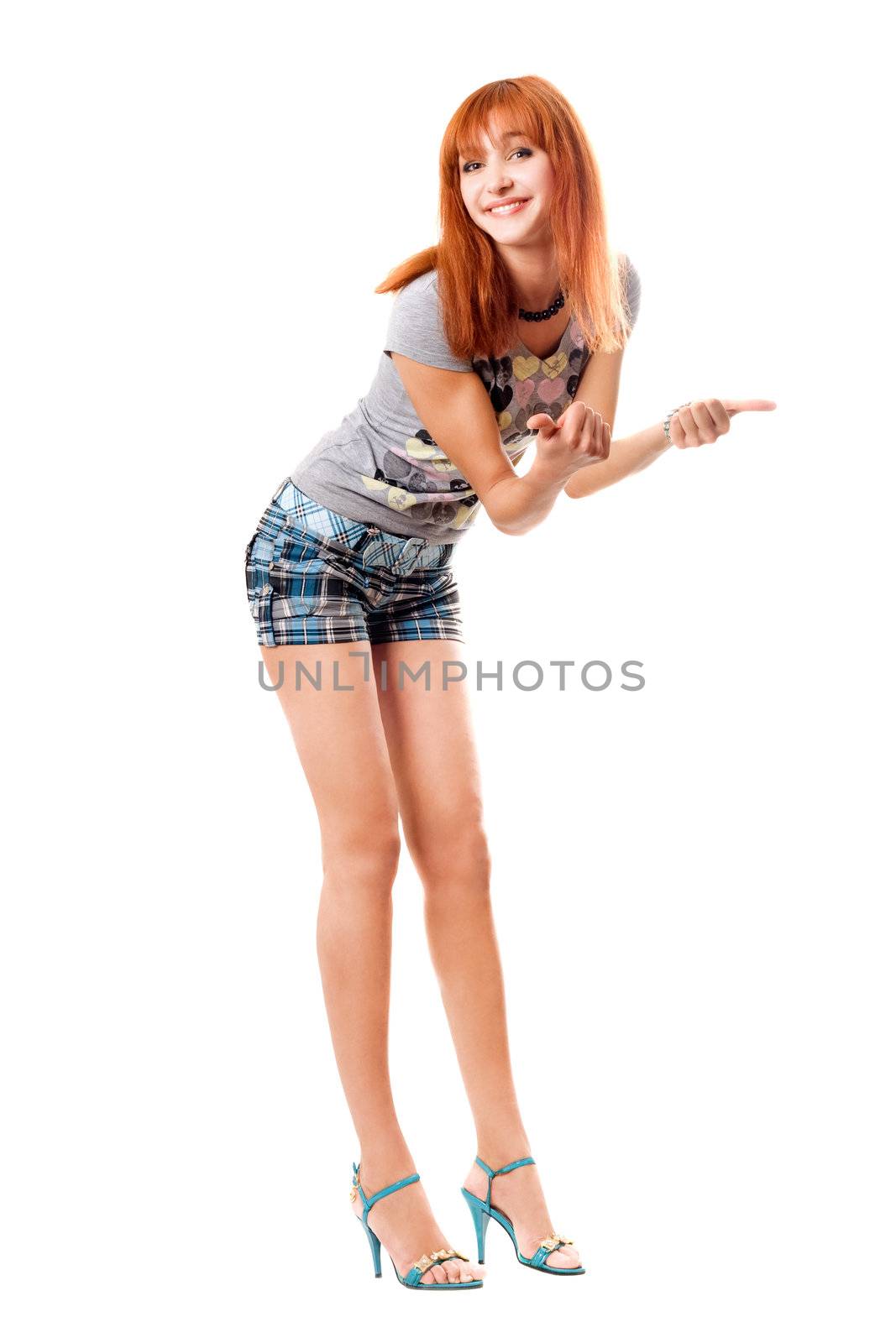 Cheerful red-haired girl in a t-shirt and shorts