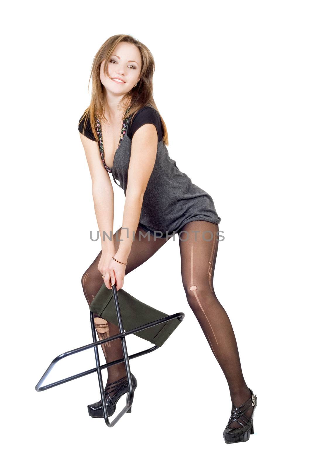 Young woman in the torn stockings with a chair