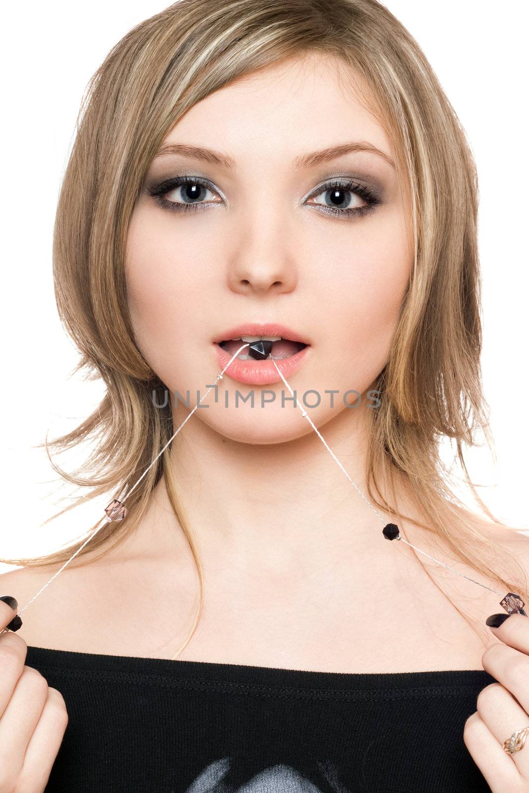 Portrait of attractive young woman with a bead in her mouth