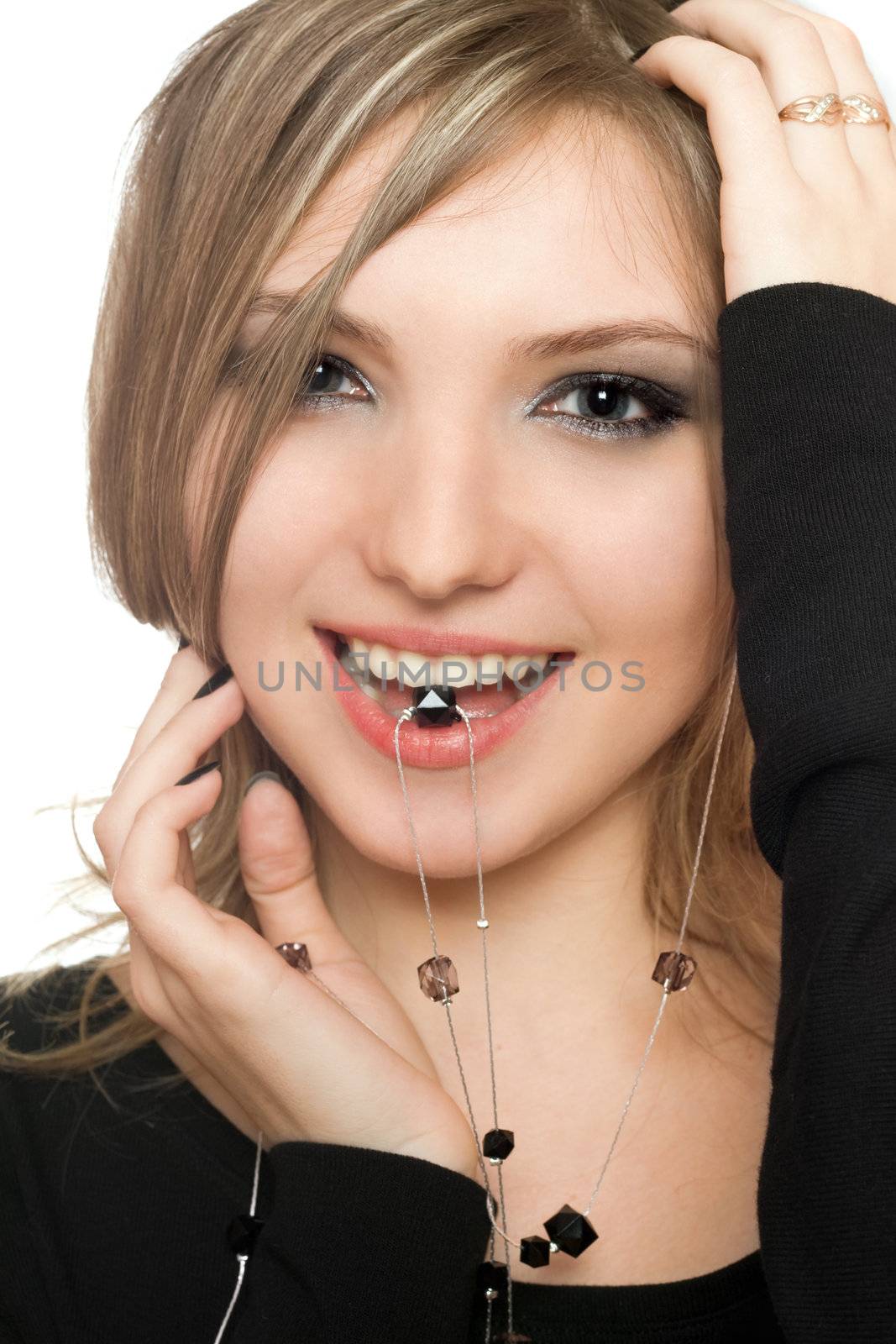 Close-up portrait of smiling girl with a bead in her mouth