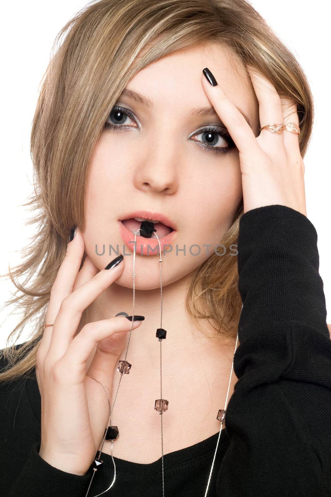 Close-up portrait of sensual young woman with a bead in her mouth