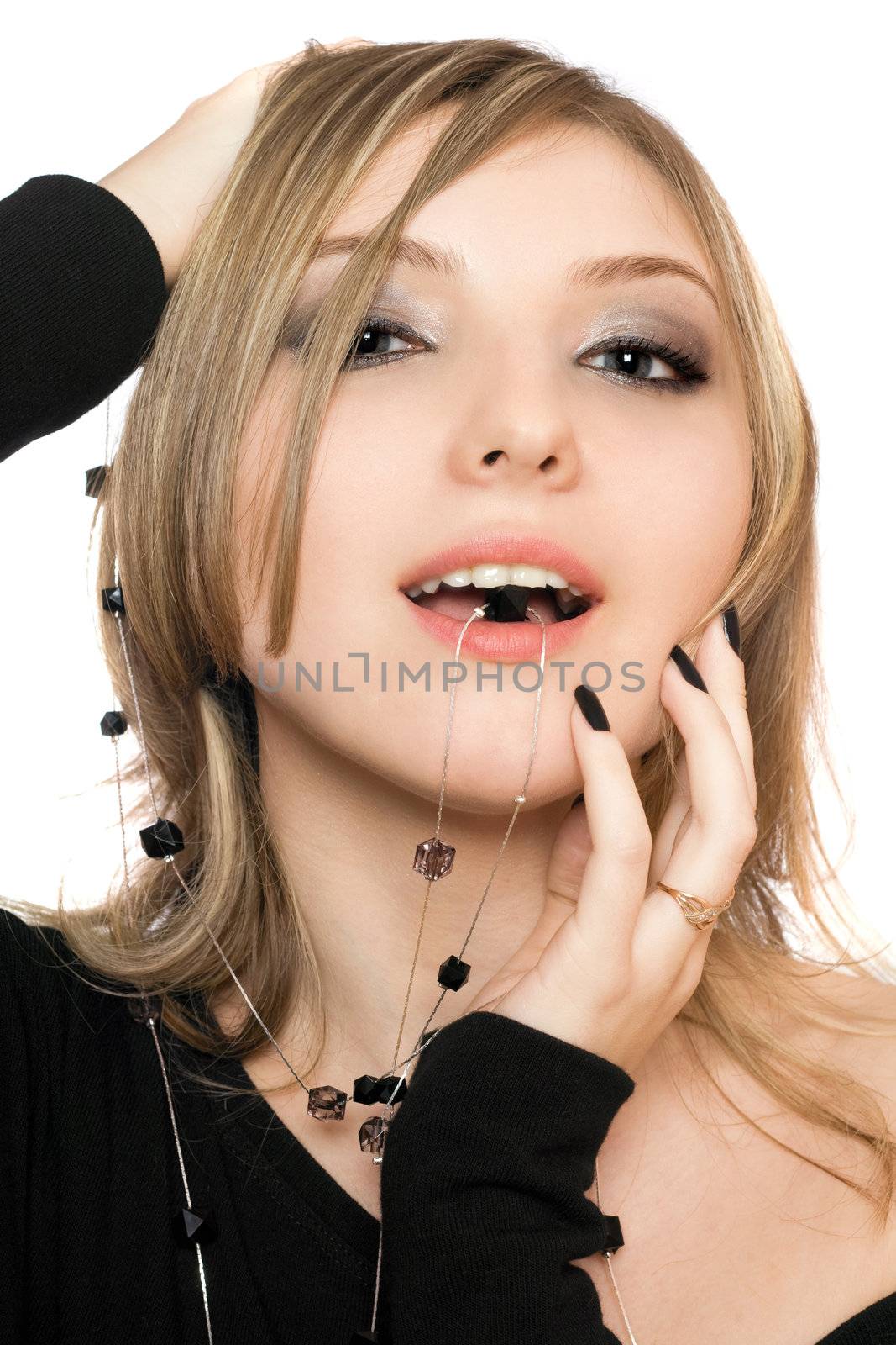 Close-up portrait of playful girl with a bead in her mouth