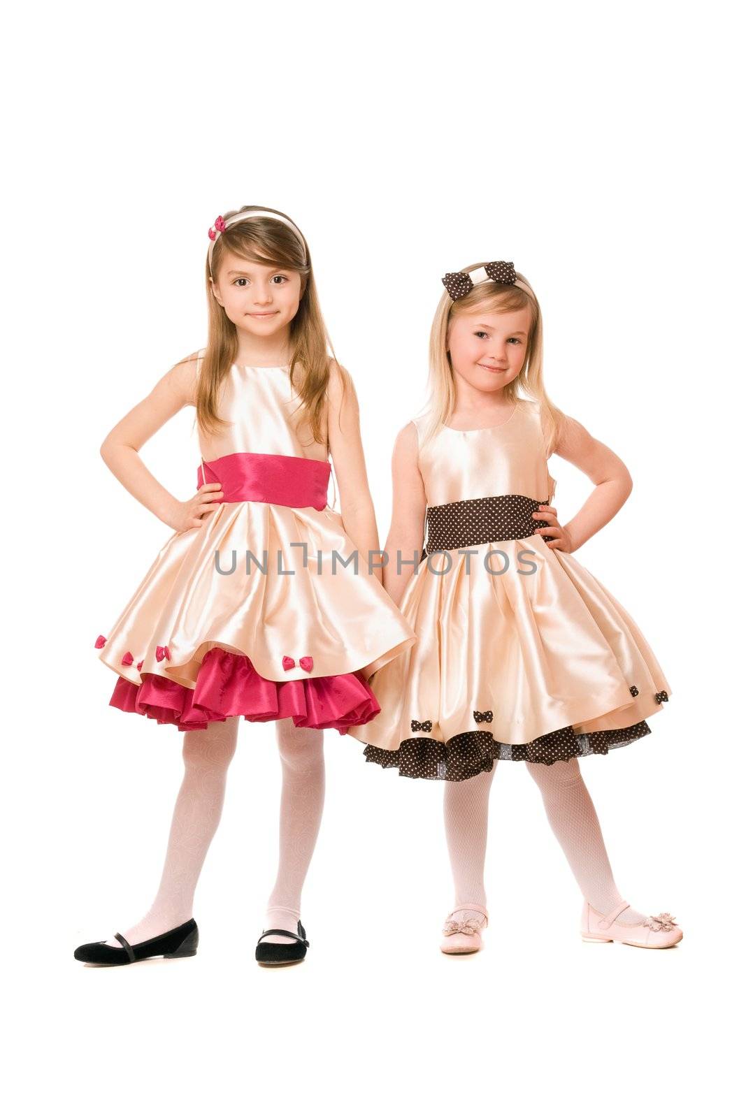 Two beautiful little girls in a dress. Isolated