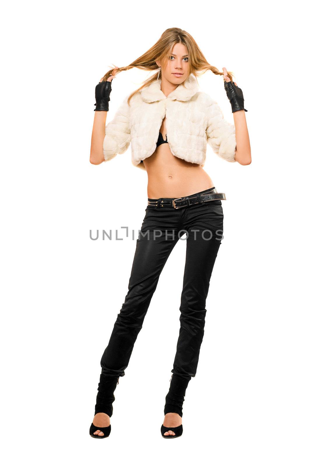 Playful young blonde in a fur coat and black jeans