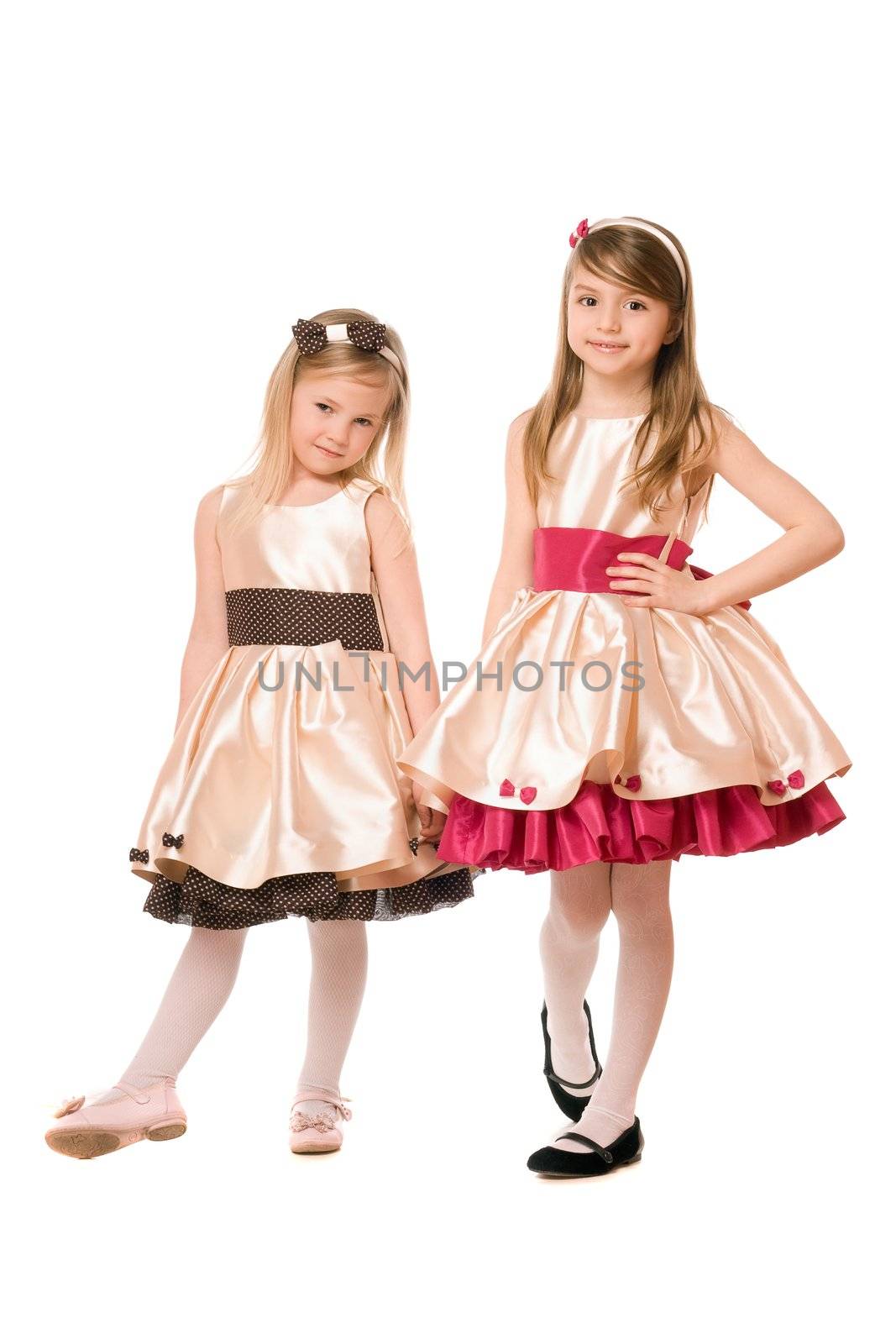 Two cute little girls in a dress. Isolated