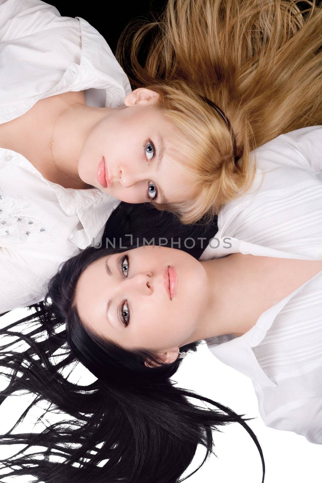 Portrait of two lying beautiful young women