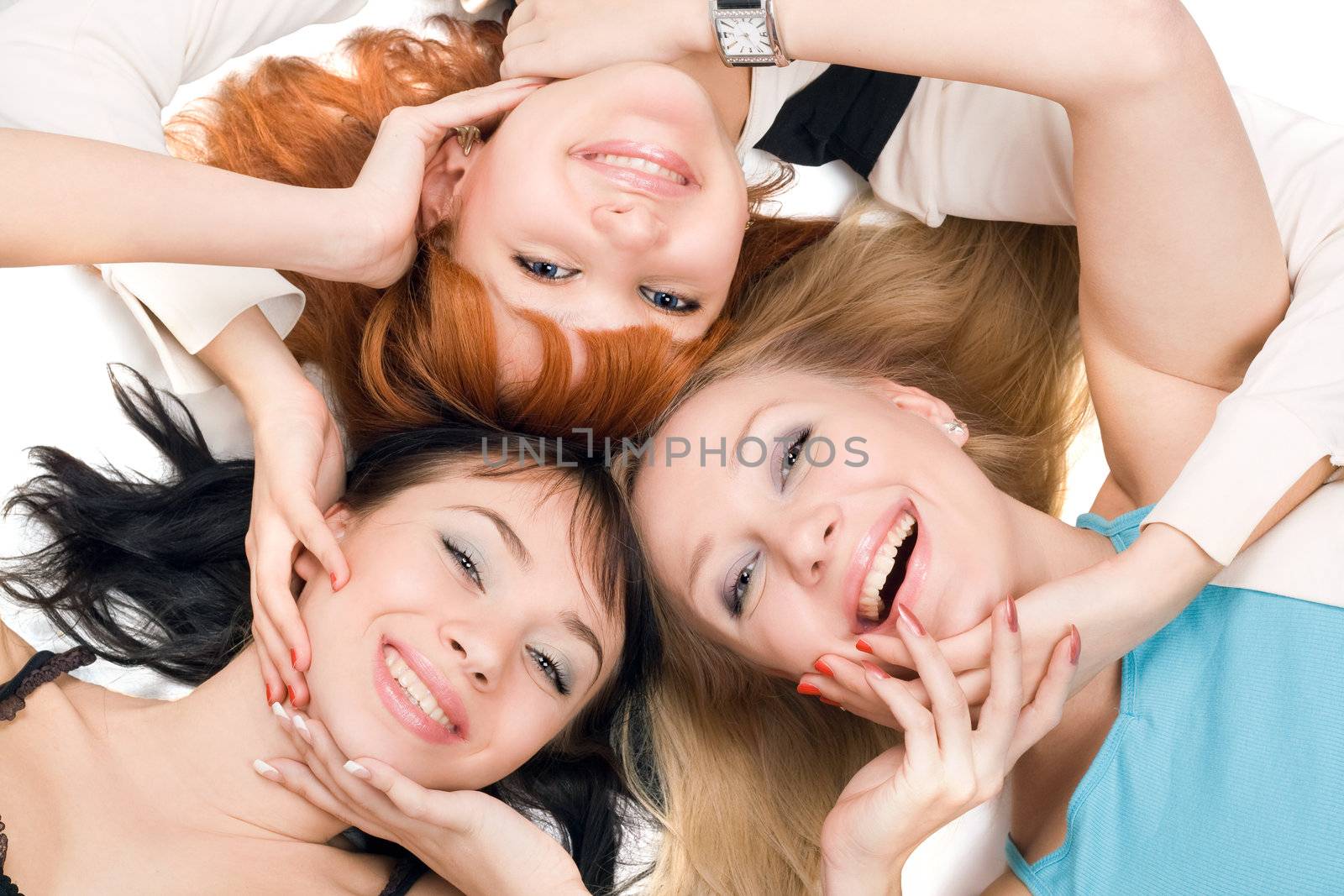 Portrait of three young playful women on white background