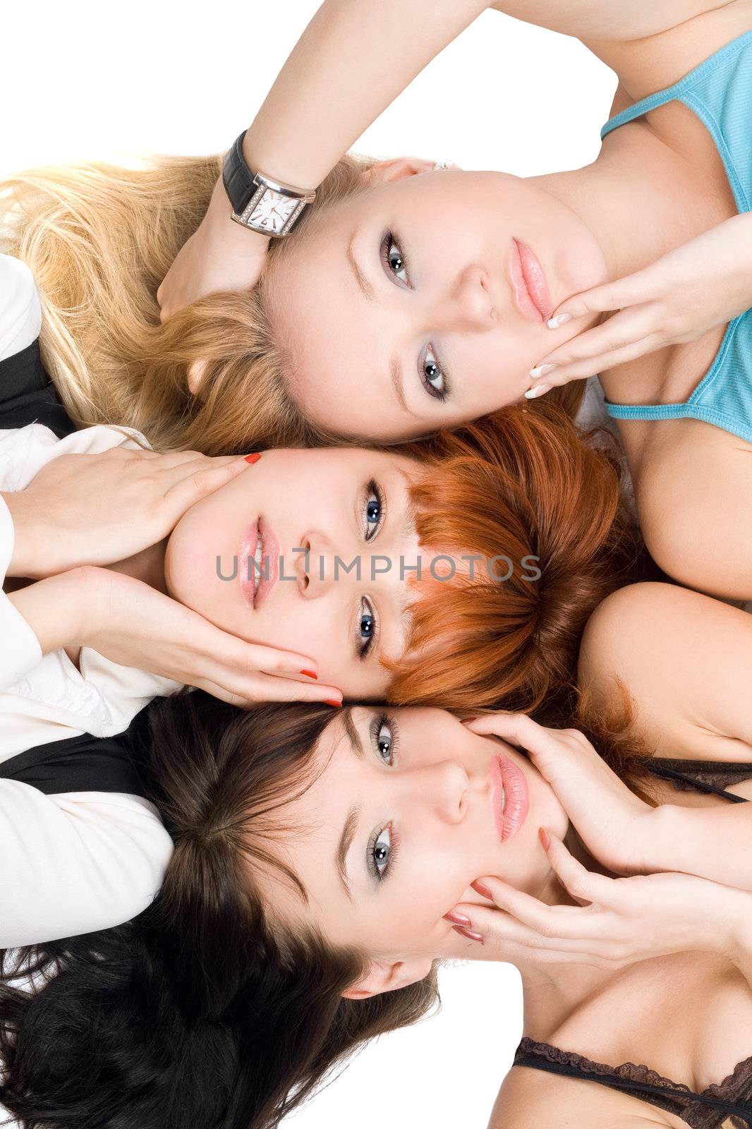 Close-up of three attractive women posing on white background