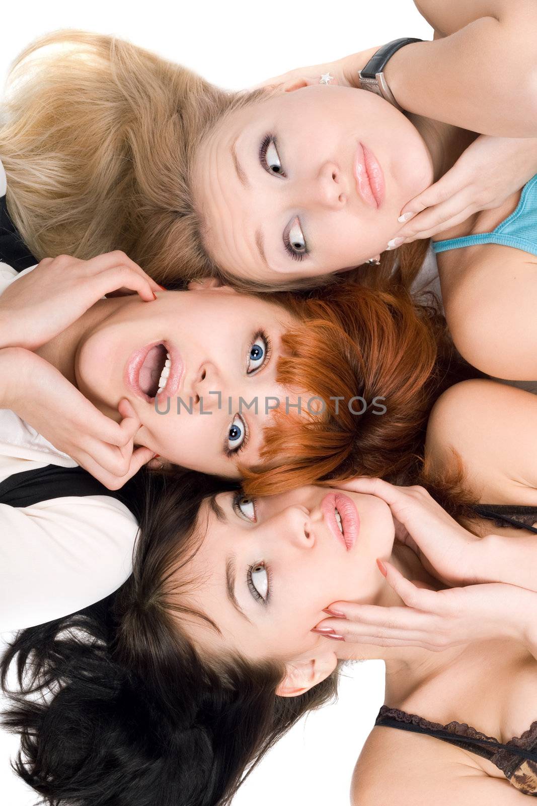 Portrait of three amazed women touching their cheeks on white background