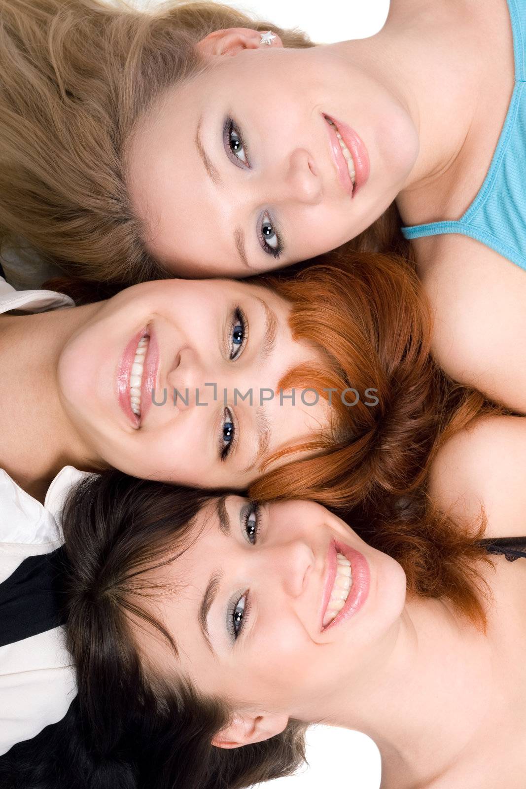 Close-up of three cheerful women relaxing on white background