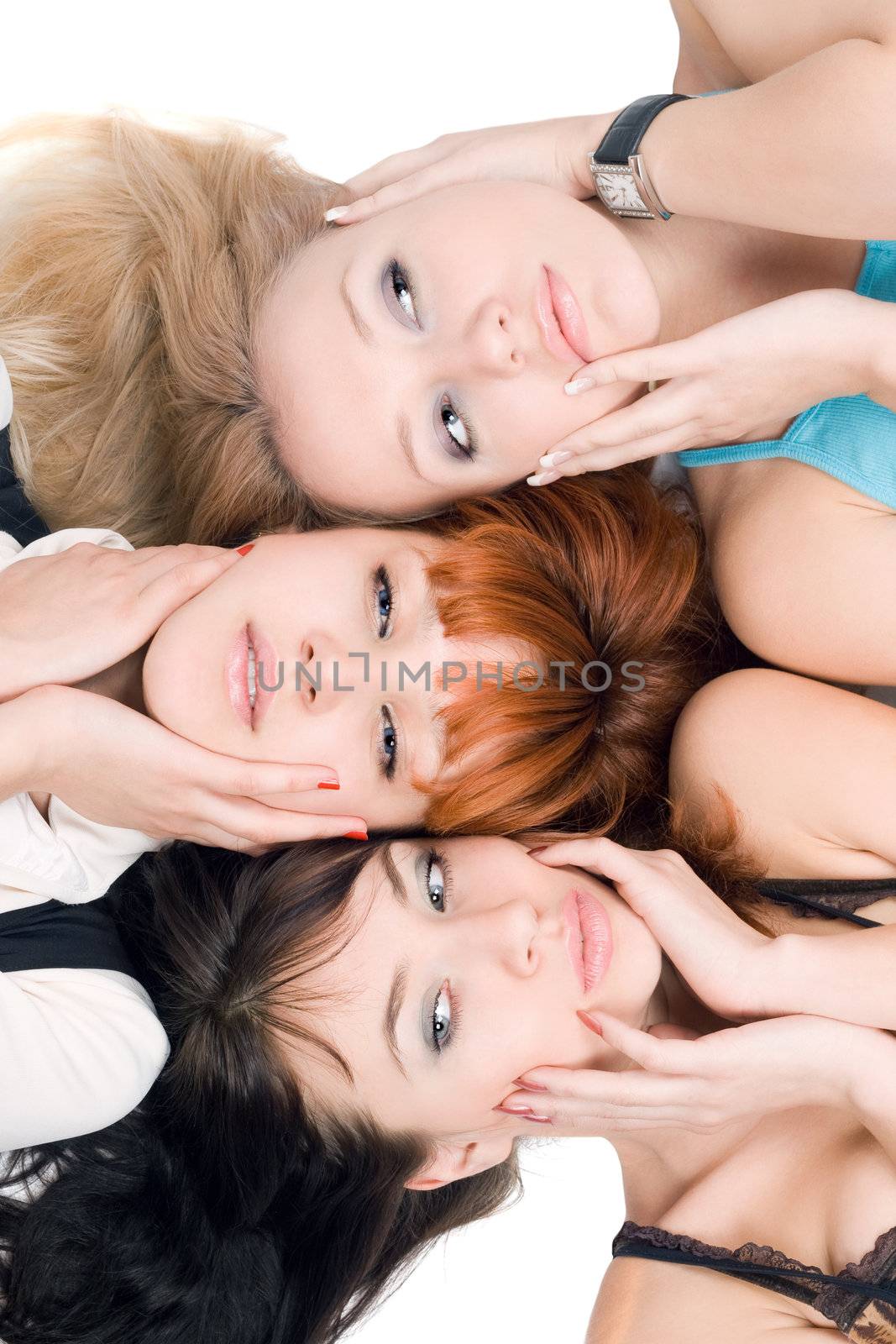 Close-up of three women posing on white background