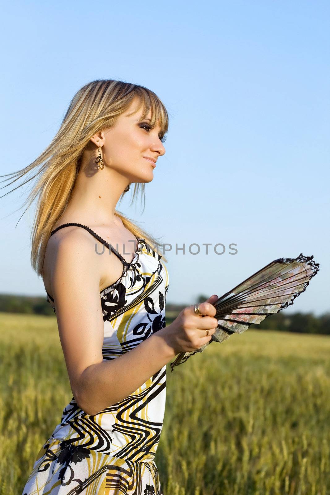 Portrait of young woman with fan in hand