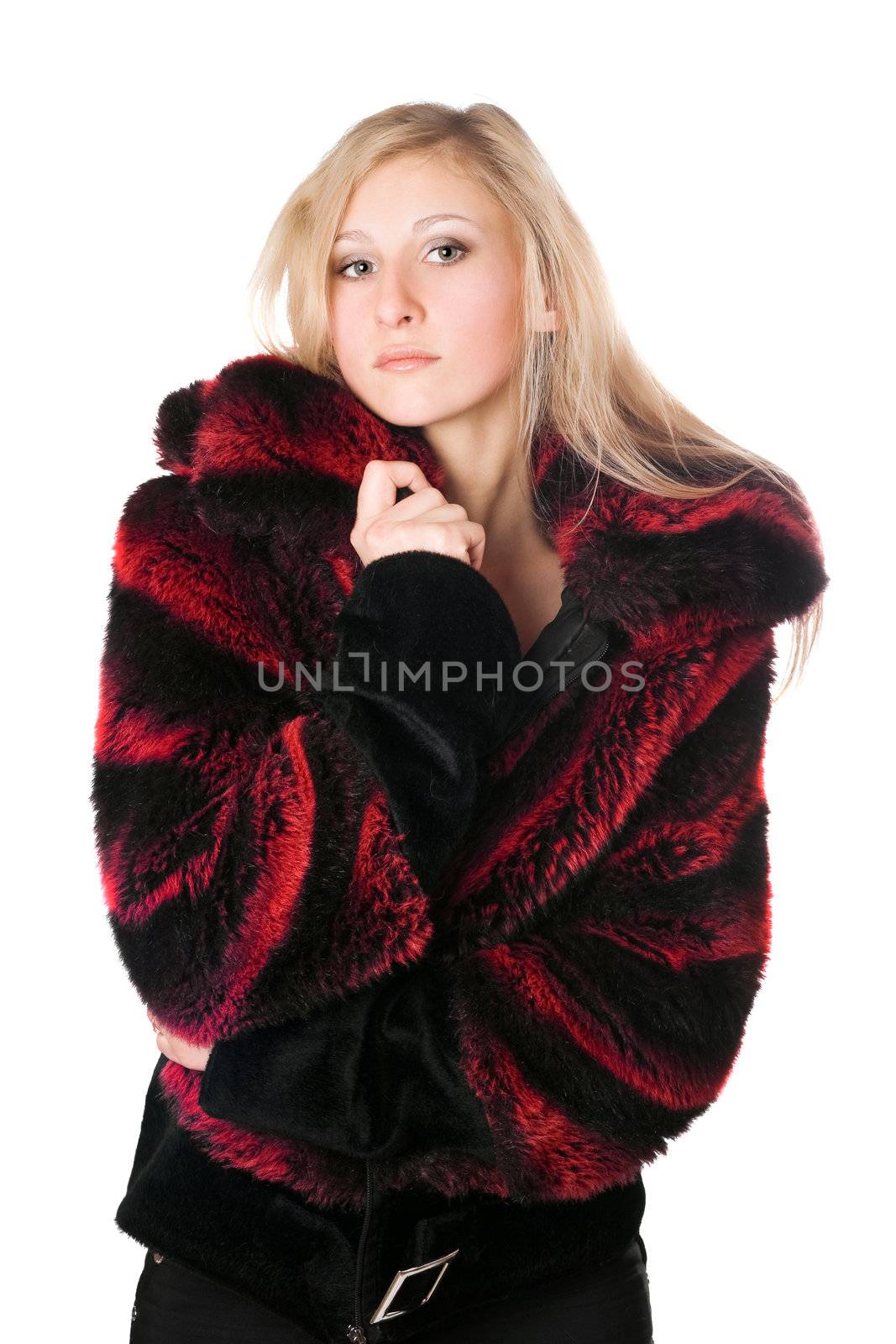 Young blond woman in a fur jacket. Isolated on white