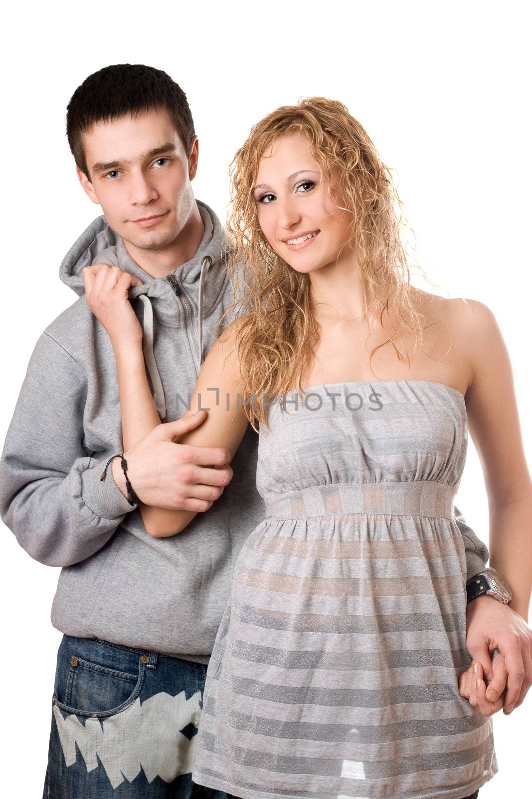 Young nice cheerful couple posing. Isolated on white