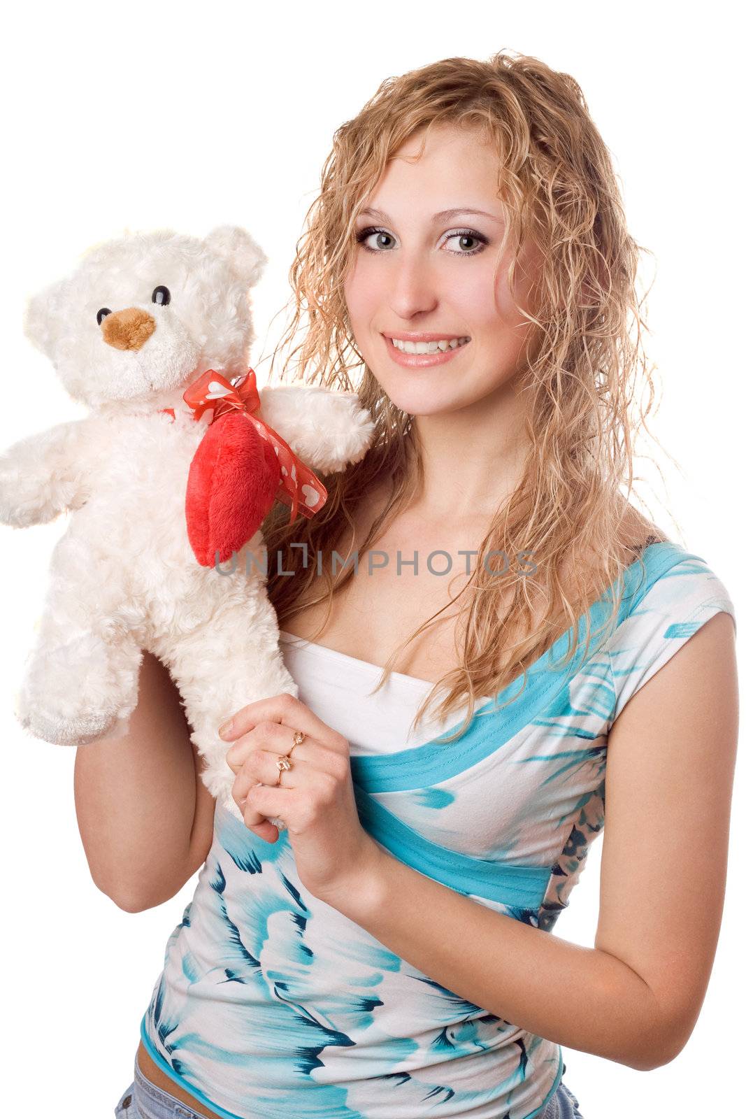 Playful smiling blonde with teddy bear. Isolated on white