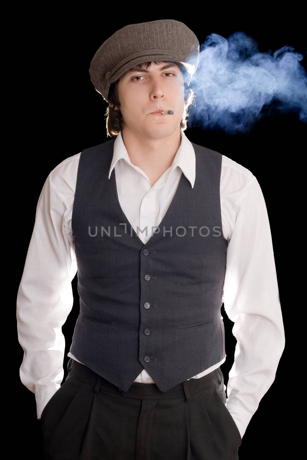 Outmoded young man with a cigarette. Isolated on black