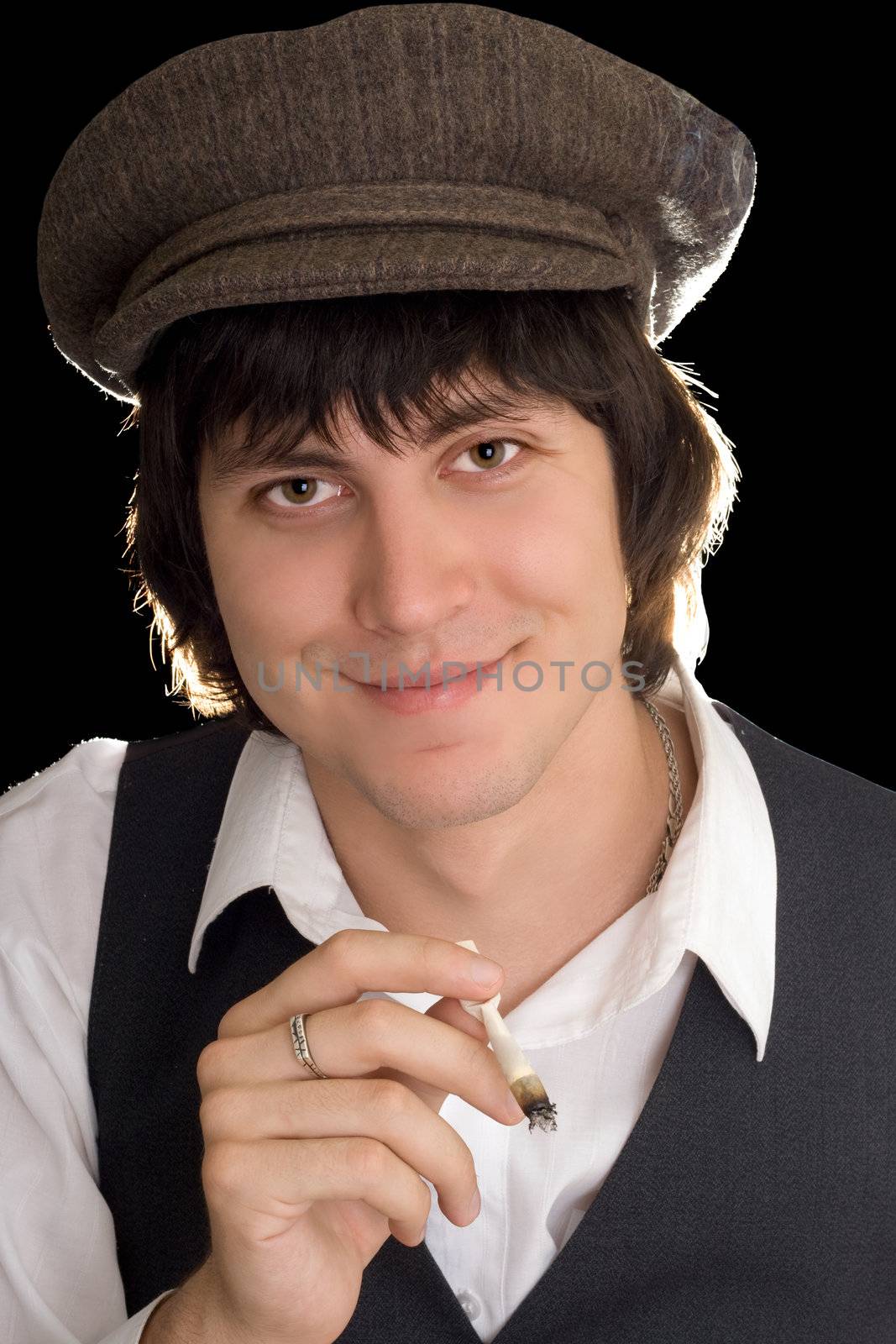 Portrait of smiling man with a cigarette. Isolated on black