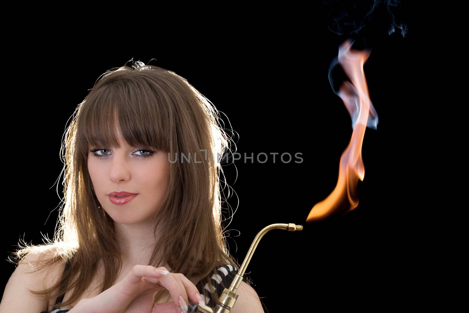 Portrait of the young woman with a gas torch