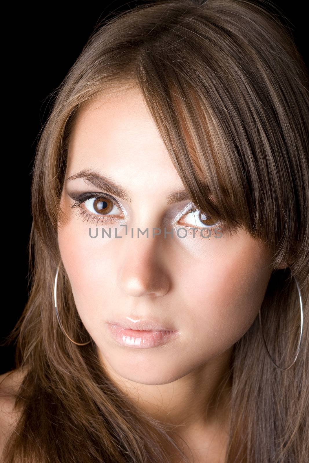 Portrait of the young woman. Isolated on black