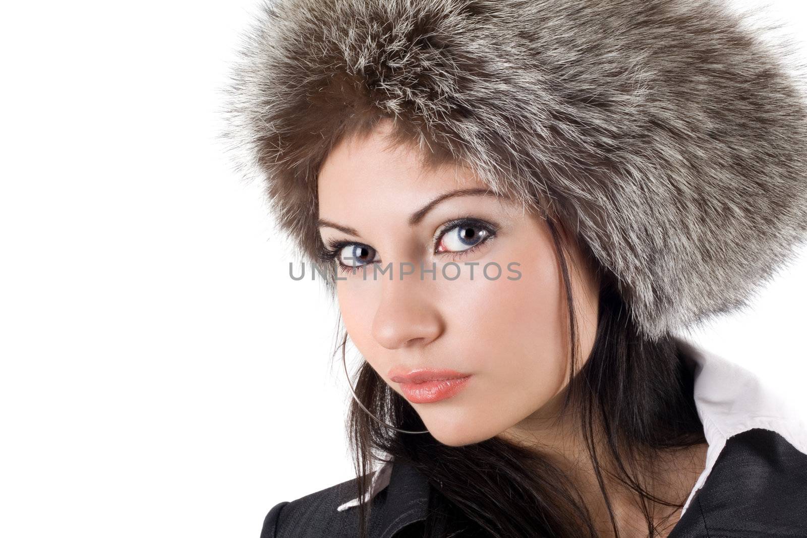 Portrait of the young woman in a fur cap
