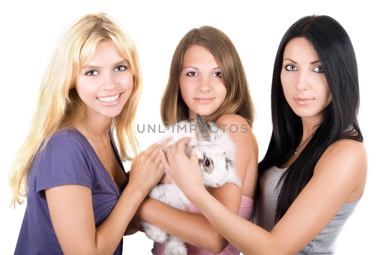 Three young women with little white rabbit. Isolated