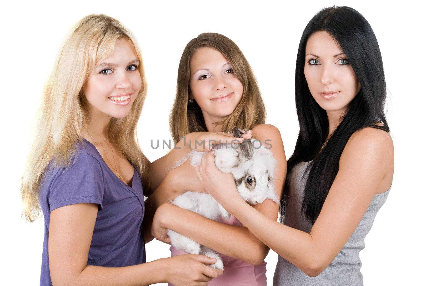 Three cheerful women with little rabbit. Isolated on white