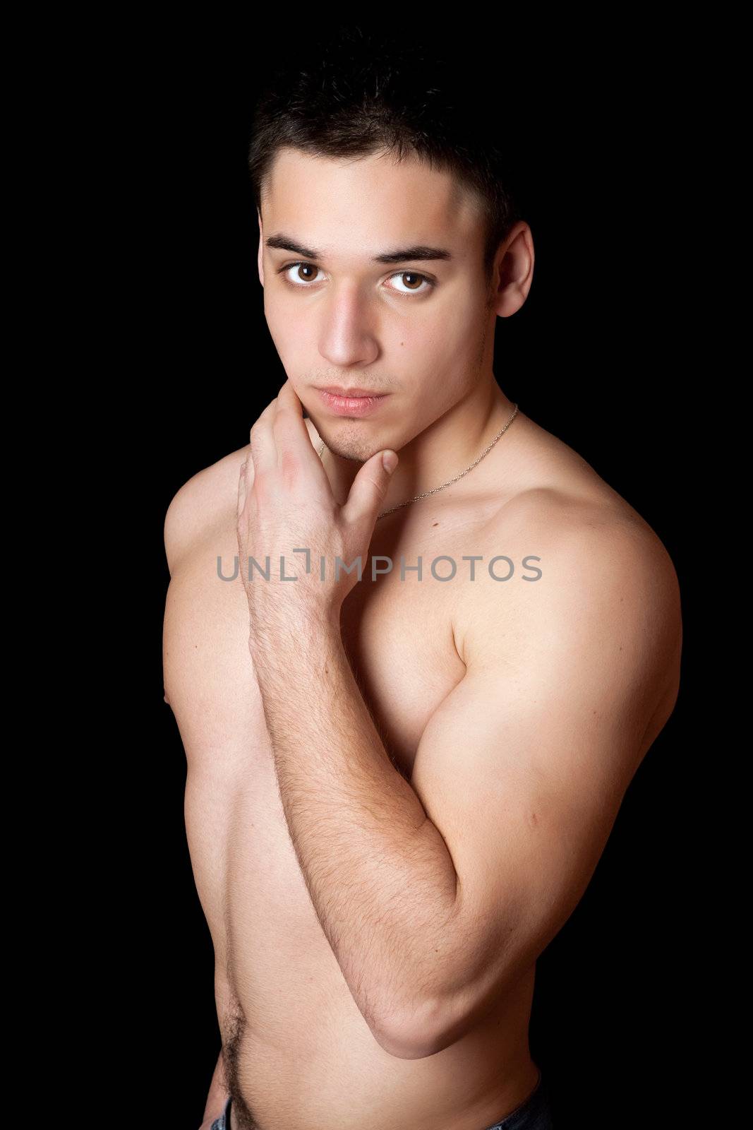 Portrait of handsome young man. Isolated on black