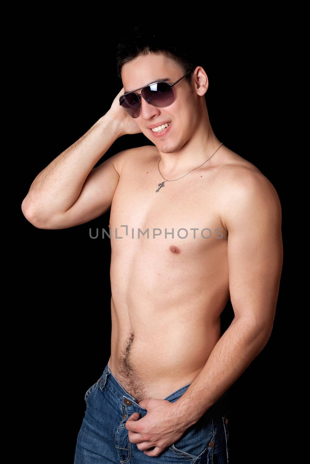 Portrait of smiling young man. Isolated on black