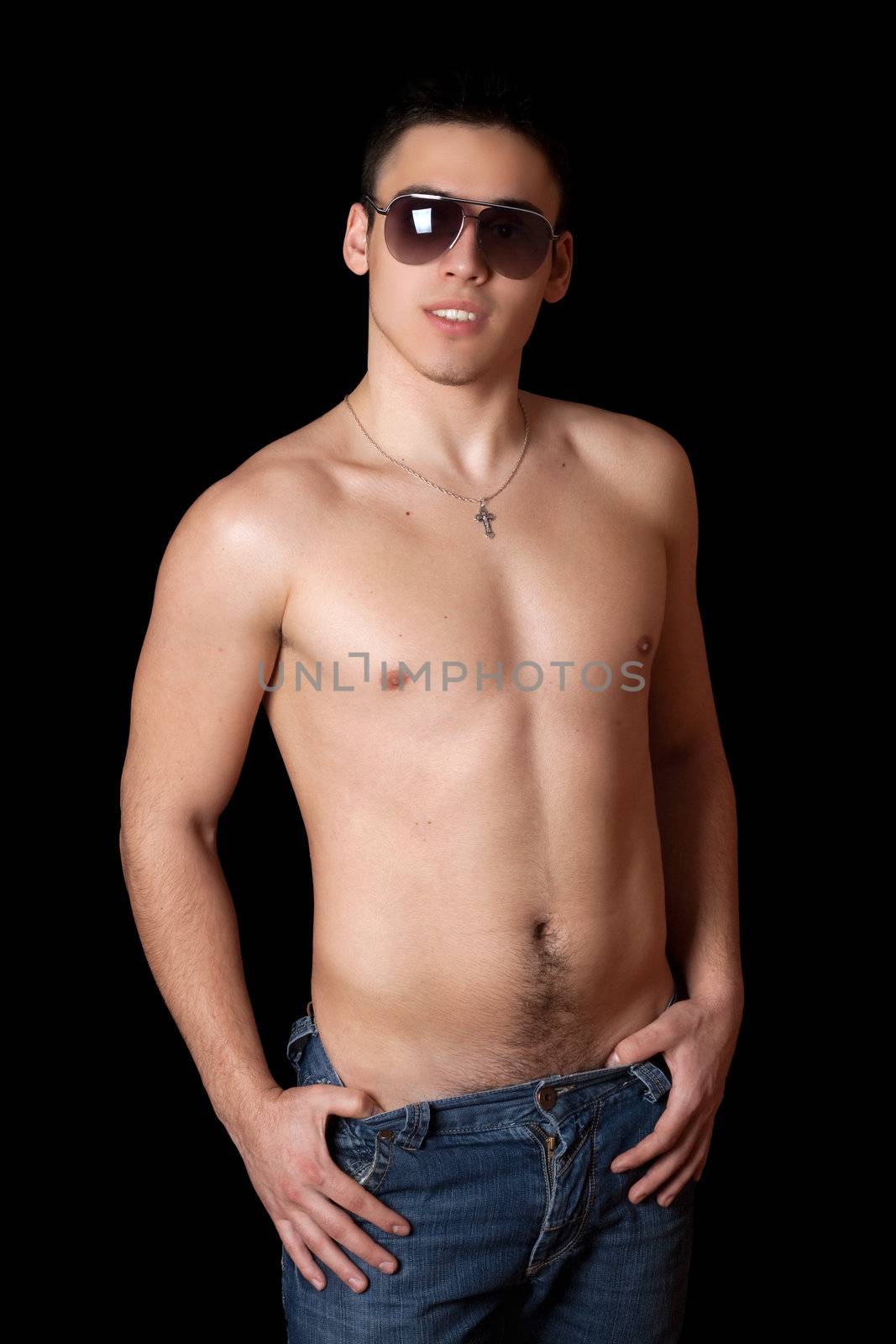Portrait of smiling handsome young man in sunglasses. Isolated on black