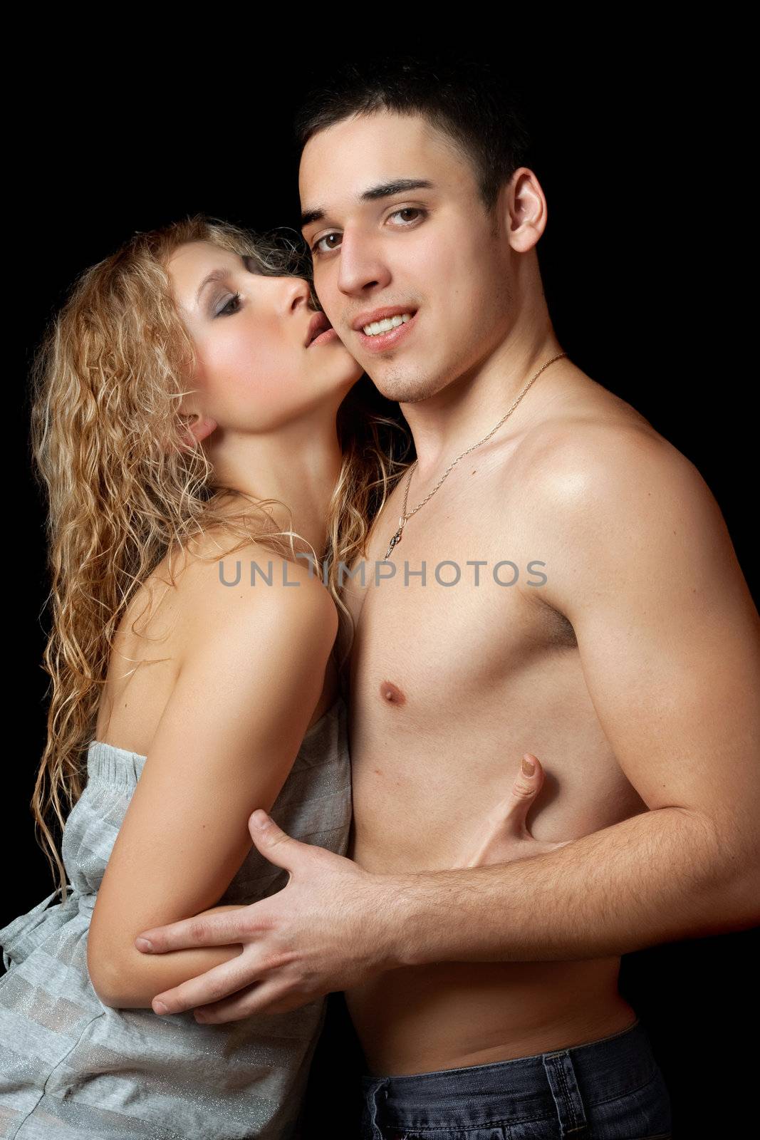 Portrait of a passionate beautiful young couple. Isolated on black