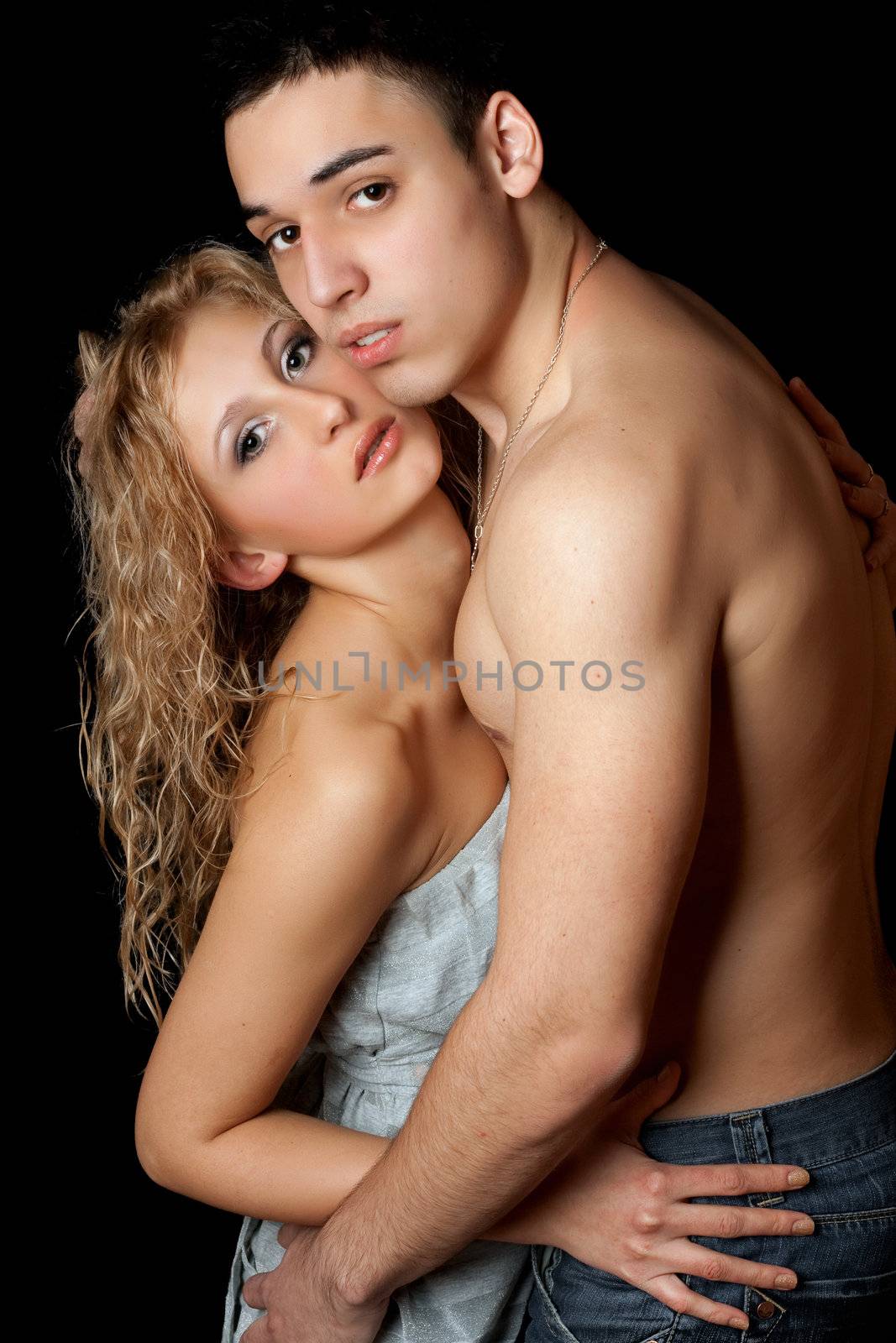 Portrait of attractive young couple. Isolated on black