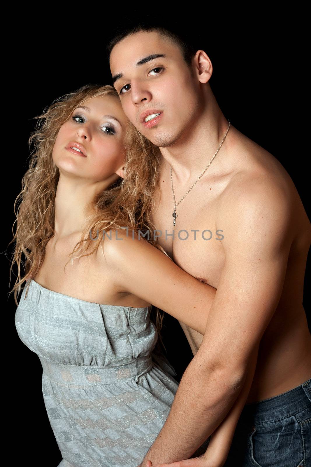 Portrait of beautiful young couple. Isolated on black