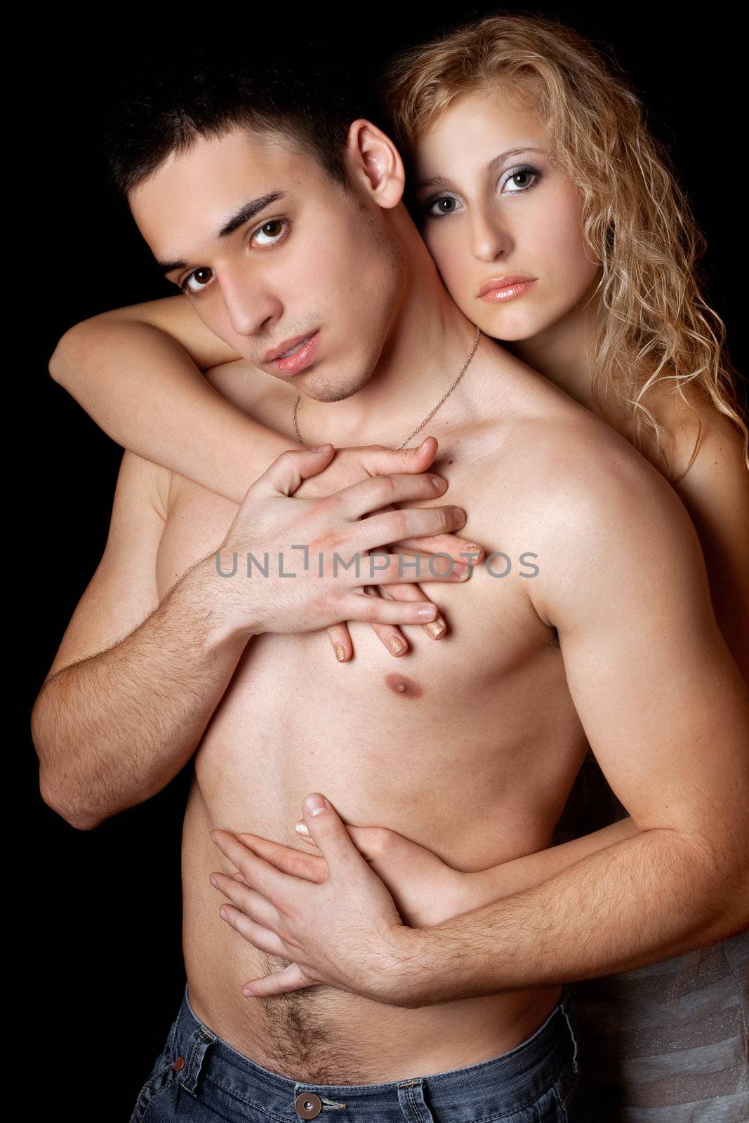 Portrait of passionate young couple. Isolated on black